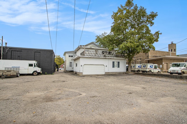 exterior space featuring a balcony and a garage