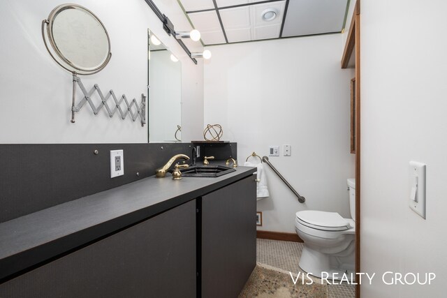 bathroom with vanity, tile patterned flooring, toilet, and decorative backsplash