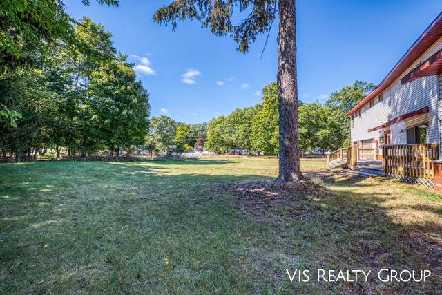 view of yard with a wooden deck