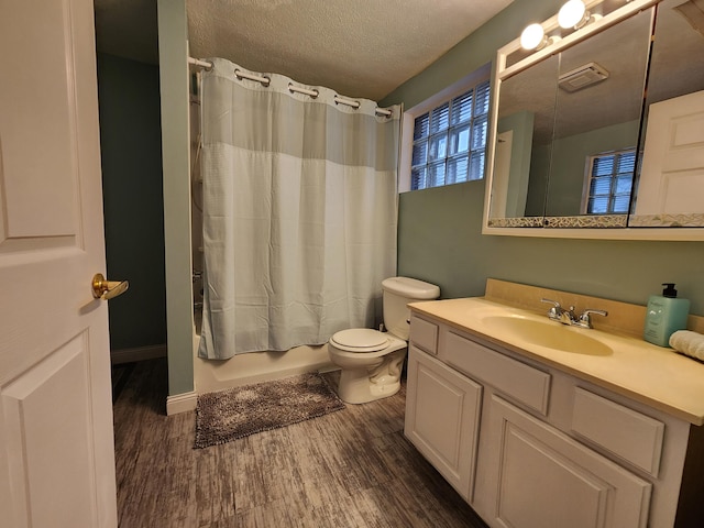 full bathroom featuring hardwood / wood-style floors, vanity, toilet, and shower / tub combo