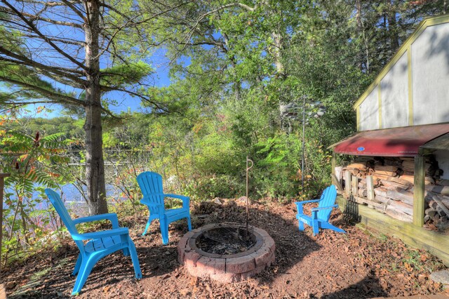 view of yard with an outdoor fire pit