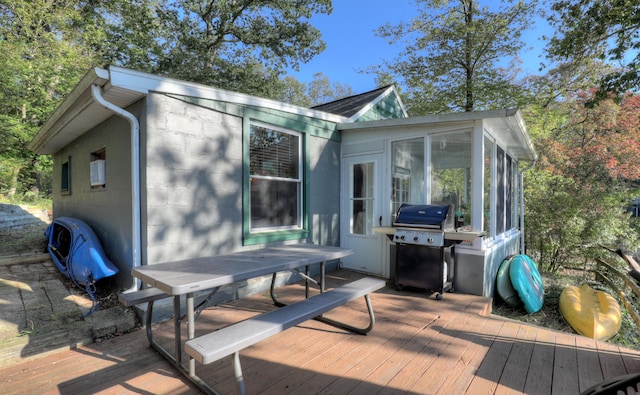 exterior space with a sunroom and a grill