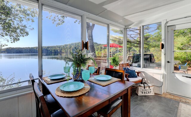 sunroom / solarium with a water view and plenty of natural light