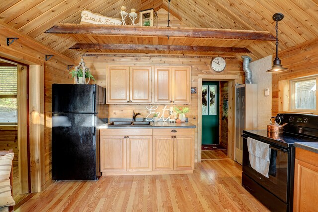 kitchen featuring light brown cabinetry, sink, hanging light fixtures, black appliances, and light hardwood / wood-style flooring