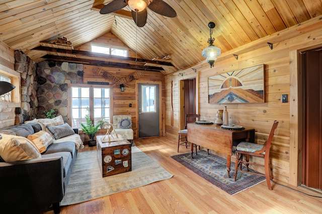 living room with vaulted ceiling, wood ceiling, light wood-type flooring, and wood walls