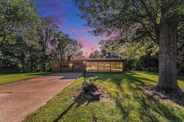 ranch-style house with a sunroom and a lawn