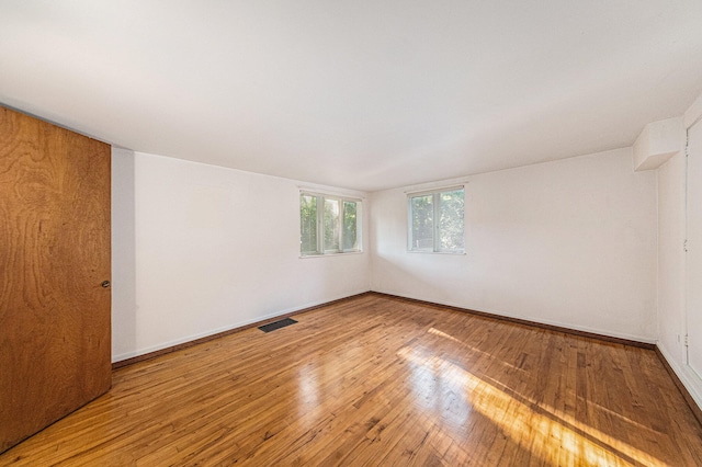 spare room with hardwood / wood-style flooring