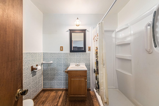 bathroom with a shower with curtain, vanity, tile walls, and hardwood / wood-style floors