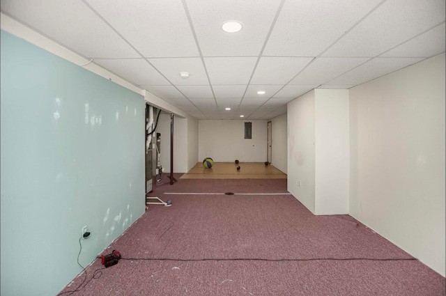 interior space featuring electric panel, carpet flooring, and a paneled ceiling