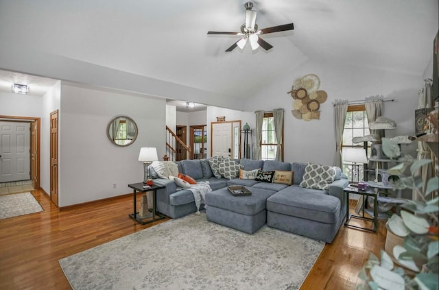 living room with lofted ceiling, ceiling fan, and hardwood / wood-style flooring