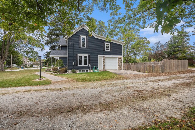 view of side of property with a lawn and a garage