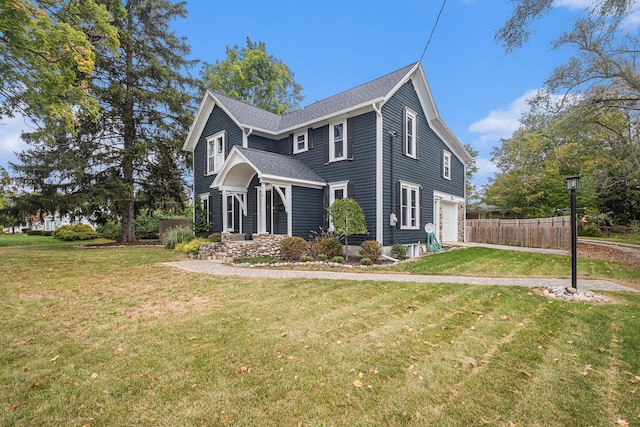 view of side of property featuring a garage and a lawn