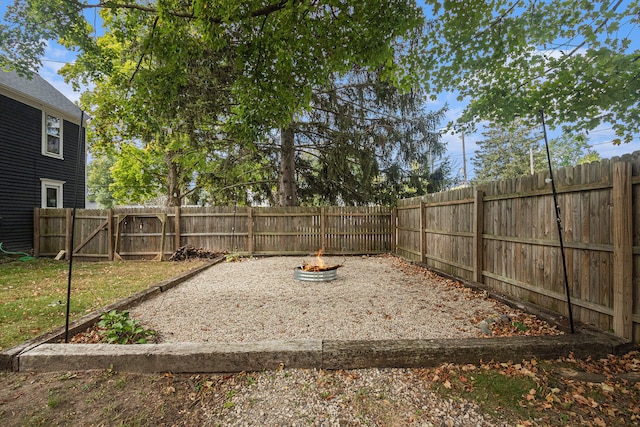 view of yard with an outdoor fire pit