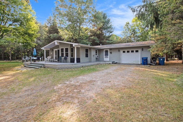 single story home with a front yard, a garage, and a wooden deck