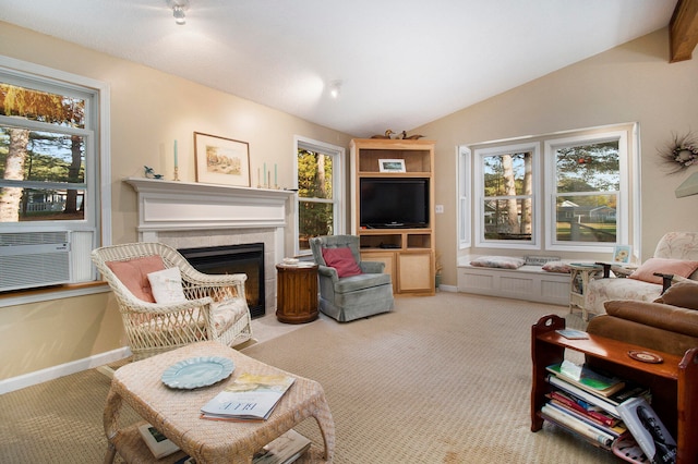 carpeted living room featuring cooling unit, vaulted ceiling, a fireplace, and a healthy amount of sunlight