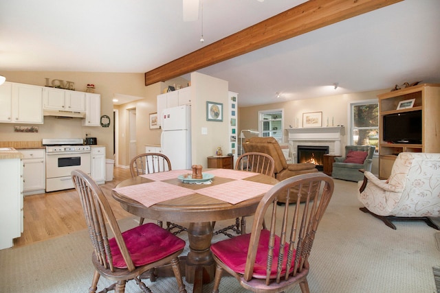 dining area with light hardwood / wood-style floors, lofted ceiling with beams, and ceiling fan