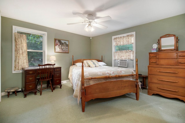 carpeted bedroom featuring ceiling fan and cooling unit