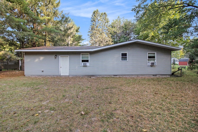 back of property featuring a lawn