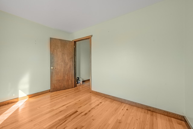 unfurnished room with wood-type flooring