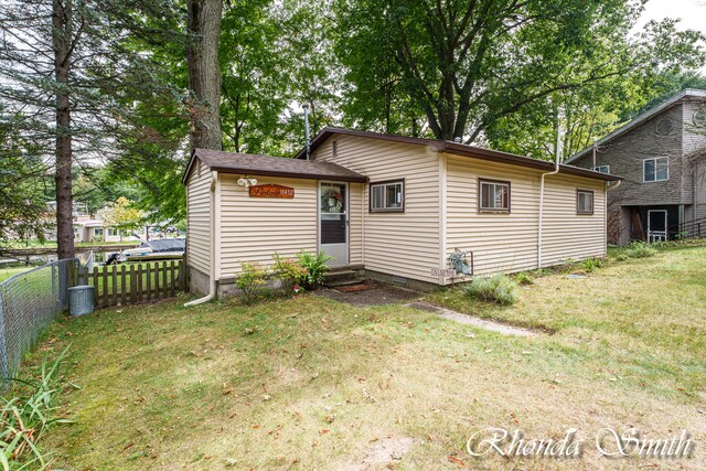 rear view of house with a yard