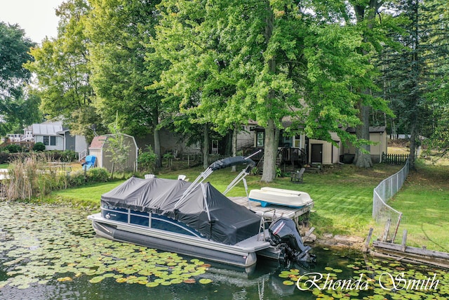 view of yard with a water view and a storage unit