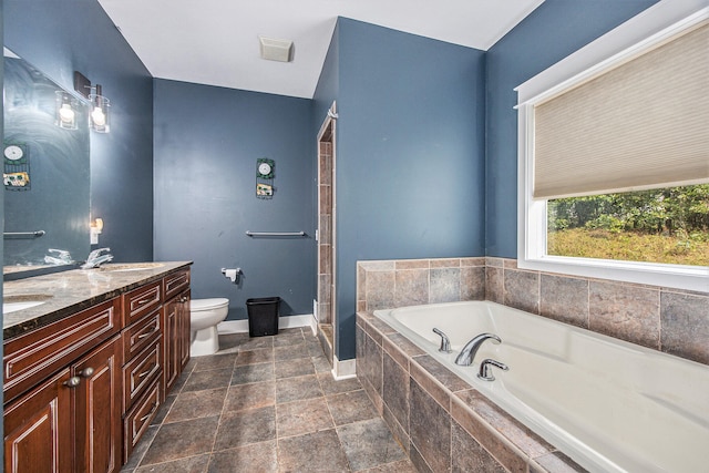 full bathroom featuring vanity, toilet, and separate shower and tub