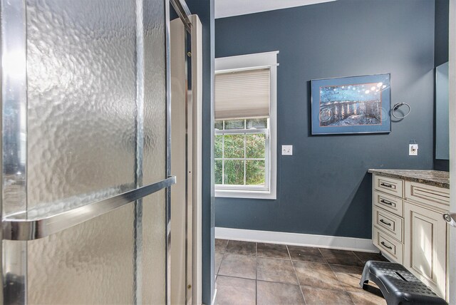 bathroom featuring tile patterned flooring and vanity