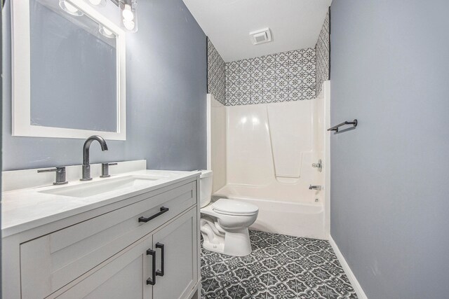 full bathroom with vanity, tub / shower combination, and toilet