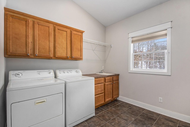 laundry room with cabinets, washer and dryer, and sink