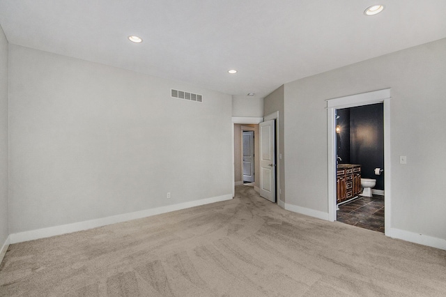 unfurnished room featuring dark carpet