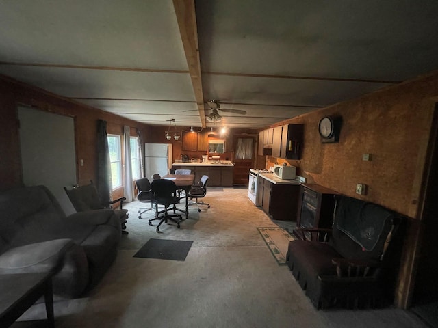 living room featuring ceiling fan and beam ceiling