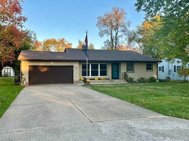 ranch-style home with a front lawn and a garage