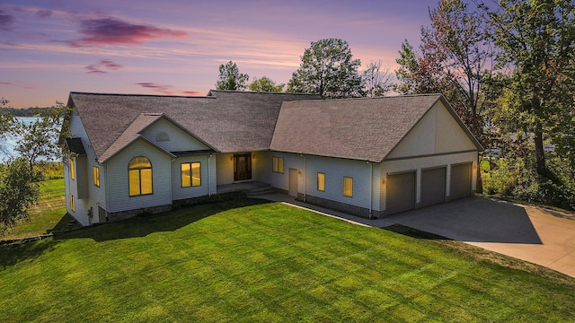 view of front of house featuring a lawn and a garage