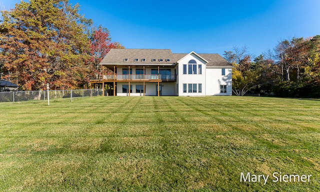 rear view of property with a yard