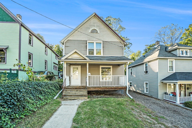 view of front facade featuring covered porch and a front yard