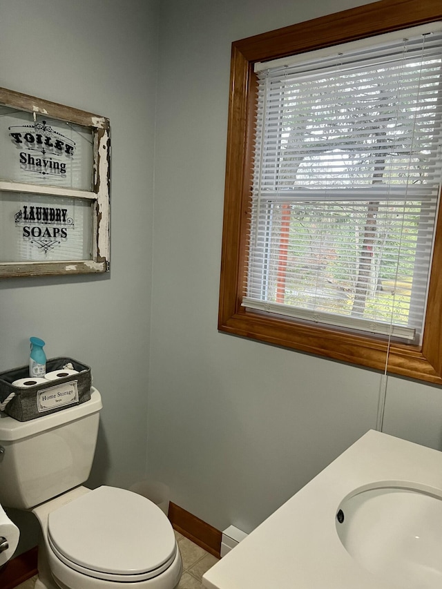 bathroom featuring tile patterned flooring, toilet, and sink