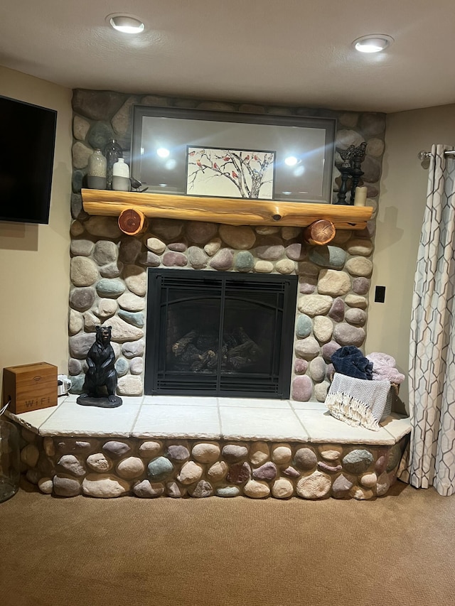 room details featuring carpet floors and a fireplace