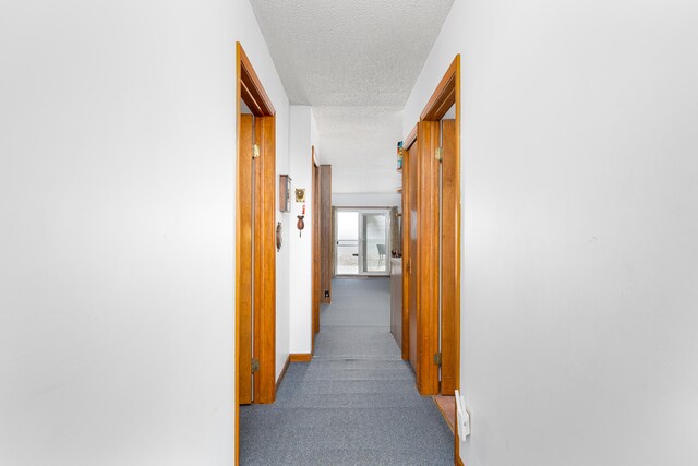 corridor with a textured ceiling