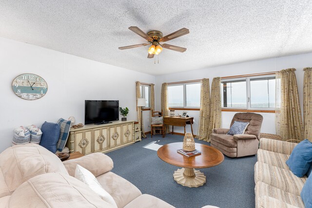 carpeted living room featuring ceiling fan and a textured ceiling