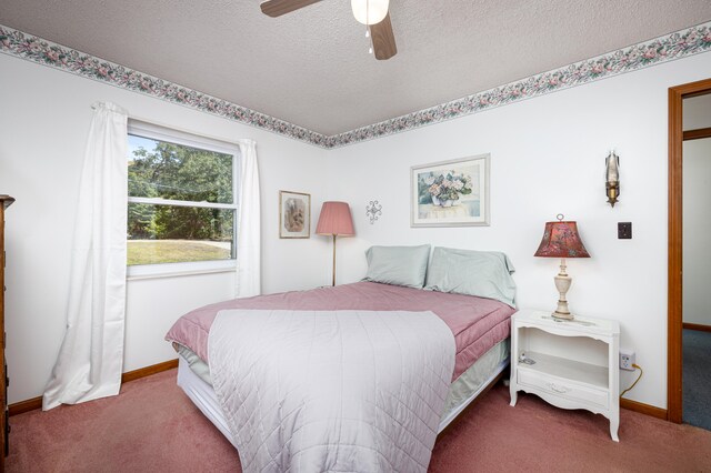 carpeted bedroom featuring ceiling fan and a textured ceiling