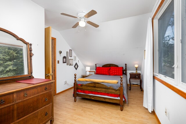 bedroom featuring ceiling fan, light hardwood / wood-style flooring, and vaulted ceiling