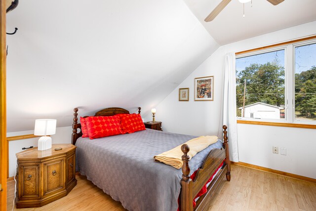 bedroom with ceiling fan, light hardwood / wood-style flooring, and lofted ceiling