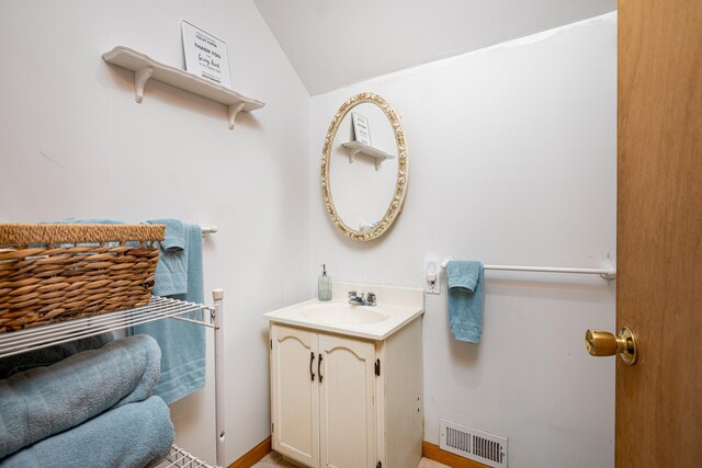 bathroom featuring vanity and vaulted ceiling