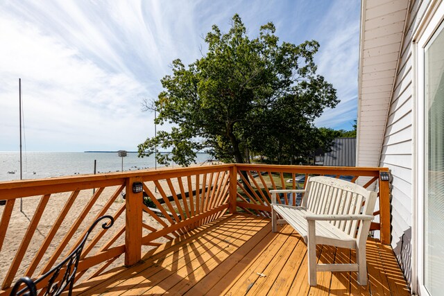 wooden deck featuring a water view