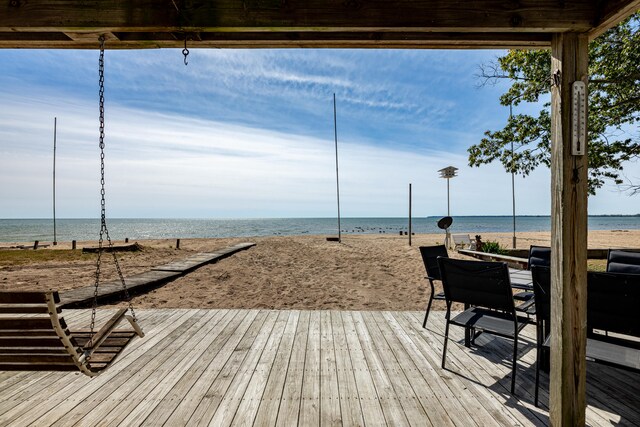 wooden terrace with a beach view and a water view