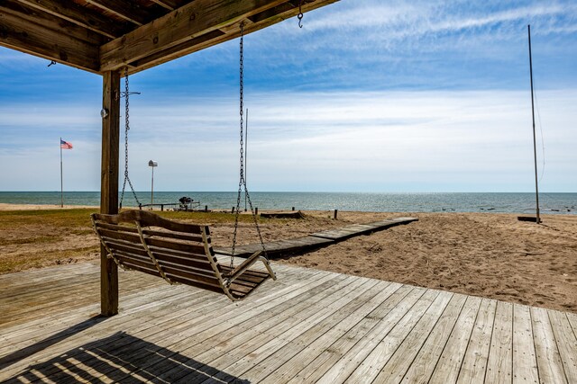 surrounding community with a view of the beach and a water view