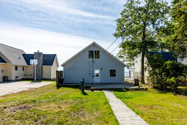 view of front of house with a patio area and a front yard