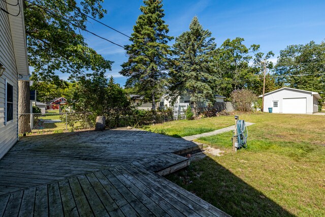 wooden terrace with an outbuilding and a yard