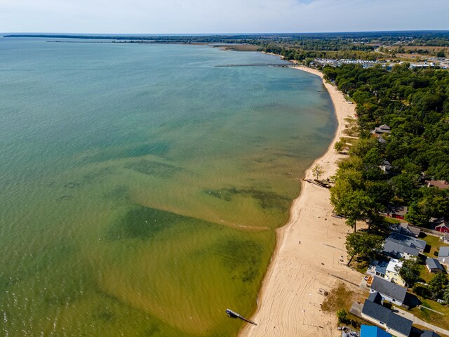 bird's eye view with a water view and a beach view