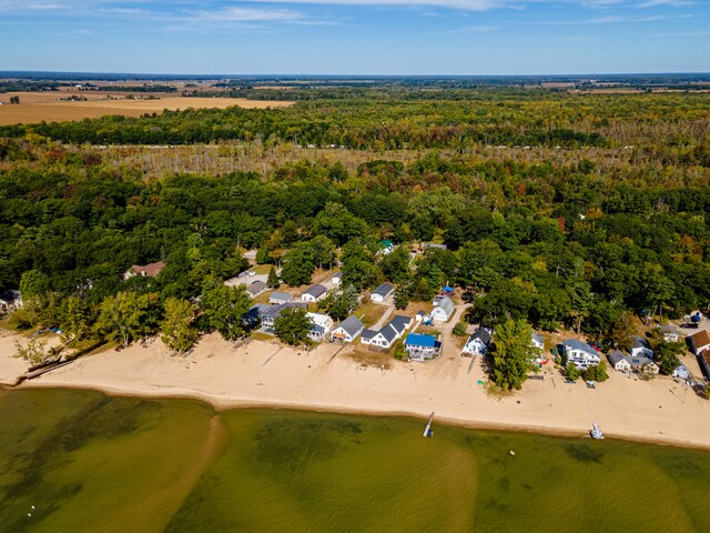 bird's eye view with a water view and a beach view